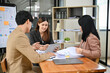 © bongkarn - Group of a professional Asian businesspeople working together in the meeting room.