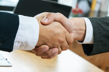 Wall Mural - Partnership. two business man investor handshake deal with partner after finishing up business meeting in meeting room office, partner, financial, teamwork, job interview, contract agreement concept