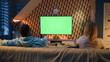 © Framestock - Woman switching channels with remote control. Couple sitting on couch in living room, talking, watching breaking news, movie or series on TV. Resting at home in the evening. Green screen. Chromakey.