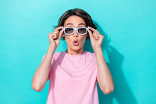 Photo Of Excited Speechless Staring Girl With Bob Hairdo Pink T-shirt Hands Hold Sunglass Impressed News Isolated On Teal Color Background