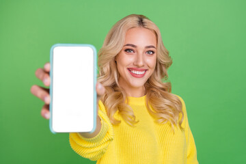 Sticker - Photo of pretty shiny lady dressed yellow pullover showing modern gadget empty space isolated green color background