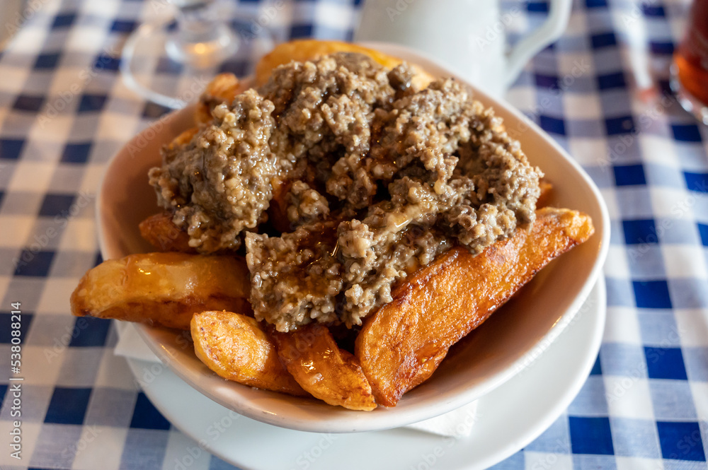 Scottish traditional snack food, hand cut potato chips topped with haggis and gravy
