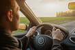 © Song_about_summer - man driving car on road, hands on steering wheel, travel or commute