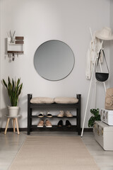 Sticker - Hallway interior with stylish furniture and round mirror on light wall