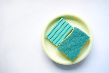 Sticker - sponge , rubber gloves and colorful plate on pink 