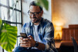 © bnenin - Businessman chatting with someone over the mobile phone, sitting