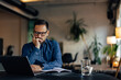 © bnenin - Concentrated man working online, making some plans and ideas, at the office.