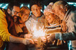 © simona - Colorful image of group of family people from young to adult and matures have fun together in friendship with sparklers light during christmas and ne year eve holiday time. Happy people leisure