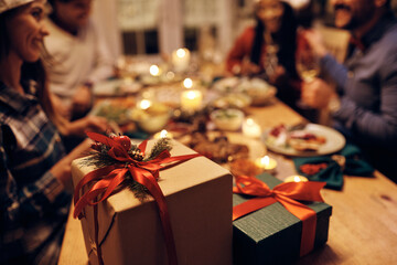 Wall Mural - Close up of gift boxes at dining table during Christmas dinner party.