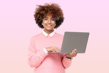 Smiling african american teen girl, high school or online course student holding laptop