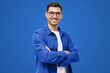 Young hispanic man wearing blue shirt and glasses, looking at camera with positive confident smile