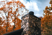 Rock Chimney With Autumn Foliage And Storm Cloud Sky