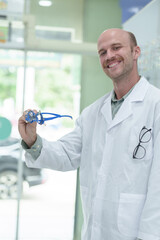 Wall Mural - Image of an optometrist holding a messbrille in an ophthalmology clinic.