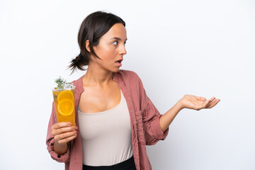 Wall Mural - Young hispanic woman holding a cocktail isolated on white background with surprise expression while looking side