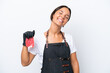 © luismolinero - Butcher hispanic woman wearing an apron and serving fresh cut meat isolated on white background laughing