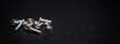 Banner of close up crafts of bolts, screws, nuts, washers, mechanical parts falling and bouncing in slow motion. black background. precision work. Work as a carpenter. Joinery and construction work.