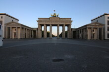 The Brandenburg Gate In Berlin, Germany In The Morning. Deserted And Sunrise In The Government Firtel And The Tiergarten. Historical Building On The Former Inner-German Border