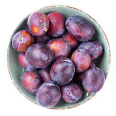 Wall Mural - Ripe plums in a bowl isolated on white background. Top view. File contains clipping path.