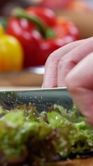 Wall Mural - Close up vertical shot of cutting salad