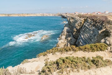 Canvas Print - View of sea waves reaching the cliffs of Peniche coastline under the blue sky