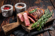 Sliced and Grilled rib eye steak, rib-eye beef marbled meat on a wooden board. Wooden background. top view