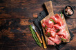 Slices of jamon serrano ham or prosciutto crudo parma on wooden board with rosemary. Wooden background. Top view. Copy space