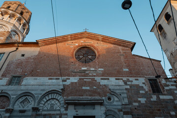 Wall Mural - beautiful old brick church with a round window at sunset in an vintage European city in Pisa, Italy