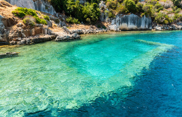 Wall Mural - Coast of Kekova island with visible underwater structures of the Sunken City, in Antalya Province of Turkey