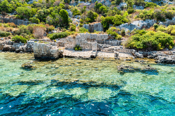 Wall Mural - Coast of Kekova island with partly submerged structures of the Sunken City, in Antalya Province of Turkey