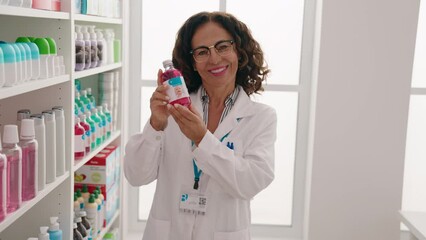 Sticker - Middle age woman pharmacist holding medication bottle at pharmacy