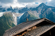 Alpine ibex, capra, resting bucolic on the roofs of alpine huts, typical image for tourists.