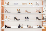 Fototapeta Boho - Elegant women's shoes on the shelves in the store. Fashion & Style. Front view.