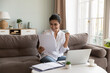 © fizkes - Happy 30s Indian woman read good news in paper letter, read bank notification about loan approval, celebrates business, study or personal success, relish achievement, new job opportunity, taxes refund