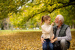 © BGStock72 - Grandfather spending time with his granddaughter in park on autumn day