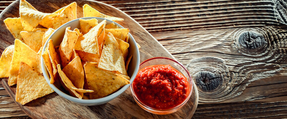 Composition with a bowl of tortilla chips and dipping sauce