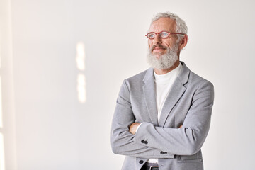 Smiling mature older successful gray-haired business man leader, thoughtful middle aged senior professional businessman crossed arms looking away thinking standing isolated on white wall, portrait.