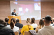 © kasto - Speaker giving a talk in conference hall at business event. Rear view of unrecognizable people in audience at the conference hall. Business and entrepreneurship concept.