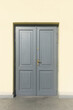 © Paweł Michałowski - Gray wooden door. Building entrance background. Empty copy space wall. Office closed door. Outdoor exterior architecture background. Golden handle and keyhole. Simple door.