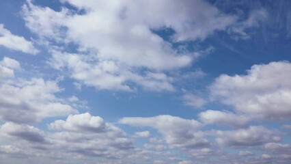 Wall Mural - Timelapse shooting white clouds moving fast in the blue sky