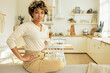 © Anatoliy Karlyuk - Cute young african american woman sitting on back of sofa with hands on waist,resting after cleaning her kitchen and living-room, looking at camera with proud confident facial expression