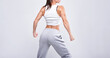 © andy_gin - No name portrait. Young white fitness woman wearing sportswear standing over white wall background. Fitness concept