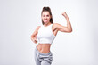 © andy_gin - Young white fitness woman wearing sportswear standing over white wall background. Fitness concept