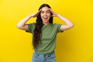 Wall Mural - Young caucasian woman isolated on yellow background with surprise expression