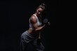 © andy_gin - Athletic fitness woman posing in the studio on a dark background. Photo of an attractive woman in fashionable sportswear. Sports and healthy lifestyle