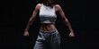 © andy_gin - Athletic fitness woman posing in the studio on a dark background. Photo of an attractive woman in fashionable sportswear. Sports and healthy lifestyle