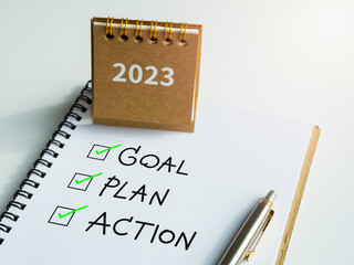 Wall Mural - Goal, plan and action, text with checkmarks on notepad with pen and small beige desk calendar on white background. Business motivation, resolution, inspiration concepts.