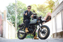 Asian Man Motorbike In Black Leather Jacket Travel Rider Trip. Handsome Men Wear Sunglass Outdoor Lifestyle Freedom Rider. Men Trendy Hipster Cool Person. Young Asian Man Hobby Ride With Motor Bike