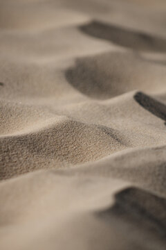 Close up on the sand of a beach. Creates the impression of a desert dune aerial view. Tilt shift effect