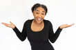 Portrait of positive young woman shrugging shoulders. Ignorant African American lady wearing black longsleeve looking at camera and smiling with clueless expression. Positivity concept