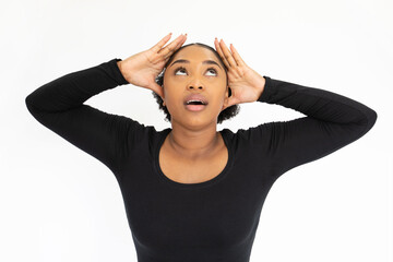 Wall Mural - Portrait of depressed young woman holding head in hands. African American lady wearing black longsleeve looking up in stress against white background. Stress and problem concept